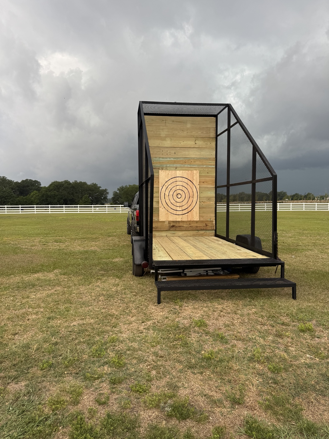 The single-lane Lane Rig trailer with an enclosed throwing lane, wooden target, and entrance steps